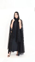 A luxurious abaya made of shimmering foil-finish chiffon, featuring black lace embellished with sparkling stones.