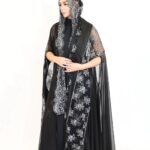 A luxurious abaya featuring premium silver and black lace combined with shimmering foil chiffon.