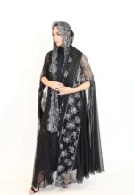 A luxurious abaya featuring premium silver and black lace combined with shimmering foil chiffon.