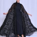 A special-occasion abaya made of tulle and embellished with luxurious crystals; includes a matching shayla for an elegant look.